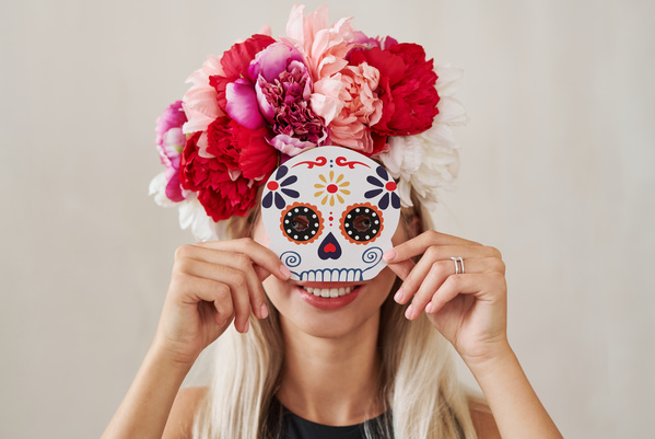 Woman with Wreath of Peonies Holds Halloween Mask